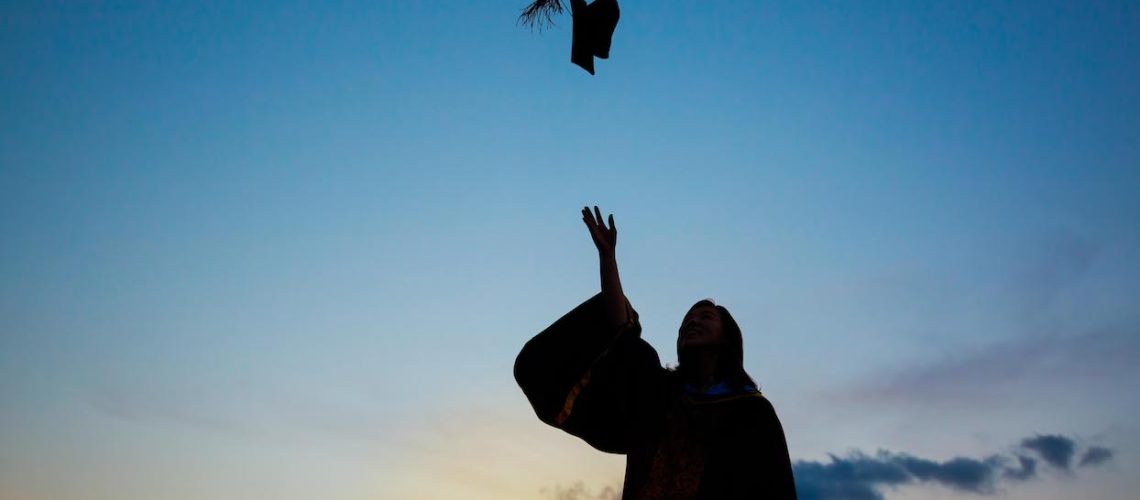 Silhouette Of Young Female Student Celebrating Graduation
